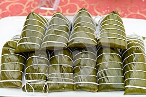 some fresh made traditional Chinese ZongZi stacked up on a table