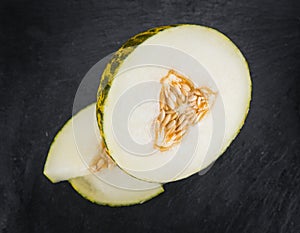 Some Futuro Melons on a dark slate slab photo