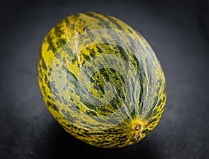 Some Futuro Melons on a dark slate slab photo