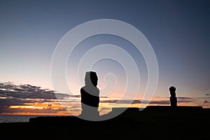 Some giant statues of Easter Island at sunset. The moai of the Ahu Tahai Ceremonial Complex, Hanga Roa, Easter Island, Chile