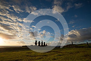 Some giant statues of Easter Island at sunset. The moai of the Ahu Tahai Ceremonial Complex, Hanga Roa, Easter Island, Chile