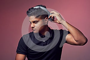 Some good music is all you need. Studio shot of a handsome young man wearing headphones.