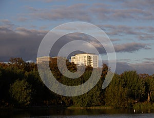 Some high rise buildings seen over the trees in the park Pildammsparken in MalmÃ¶, Sweden