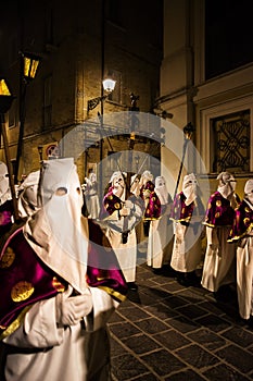 Hooded penitents during the famous Good Friday procession in Chieti (Italy) with the luminous lantern photo