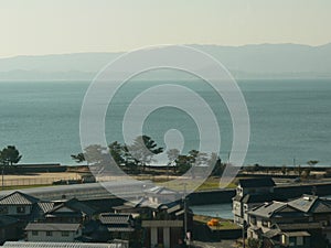 Some Japanese style design houses by the edge of a sparse ocean sea