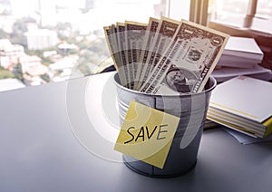 Money dollar bills in bucket for saving money