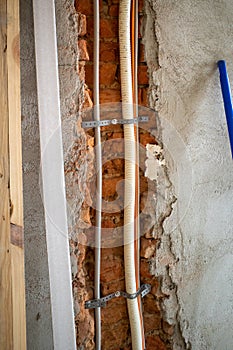 Some new cables and pipes are laid in an old building