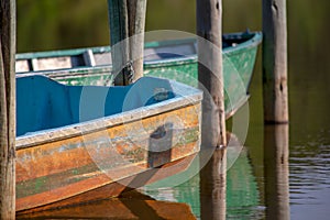 Some old boats and wooden posts on the water of the Las Coloradas lagoon VI