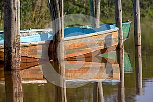 Some old boats and wooden posts on the water of the Las Coloradas lagoon VII