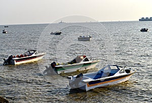 Speedboats are parked around the seashore area photograph photo