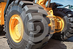 Some parts from a large car for transportation of ore called Belaz, black wheels, blue stairs and others.