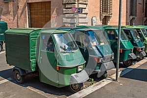 Some Piaggio Ape Tricycles side by side in Rome, Italy