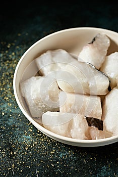 Some pieces of frozen uncooked codfish