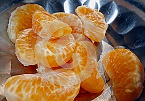 Some pieces of orange pulps kept on a plate closeup view.