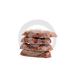 Some pieces of porous chocolate on isolated background.