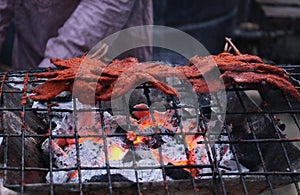 Tasty pieces of spicy beef kebabs or Nigerian suya on a grill photo