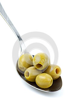 Some pitted green olives in the spoon