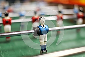 Some players on a Mini football game table in close up view