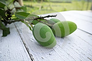 Some raw mango or kaccha aam in a wooden table