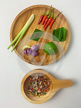 Some of the raw materials for making Matah chili sauce are lemon grass, chilies, shallots, garlic, lime leaves, lime, and shrimp