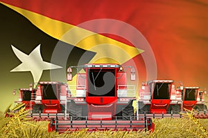 Some red farming combine harvesters on farm field with Timor-Leste flag background - front view, stop starving concept -