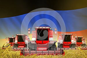 Some red farming combine harvesters on wheat field with Donetsk Peoples Republic flag background - front view, stop starving