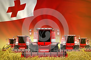 Some red farming combine harvesters on wheat field with Tonga flag background - front view, stop starving concept - industrial 3D