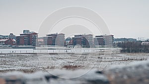 Some red residential highrise buildings in front of the lake RÃ¥bysjÃ¶n in Lund Sweden on a cold snowy day