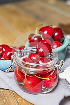 some ripe canned cherries in a clear glass jar with a lid next