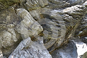 Some rock clusters with uneven rough surface under the midday sun and heat