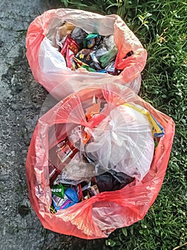 Some rubbish was placed in two red plastic bags