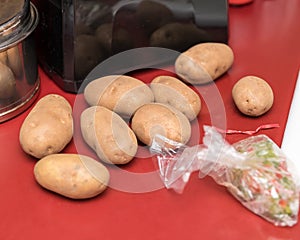 some russet potatoes waiting to be peeled and then mashed for a family dinner