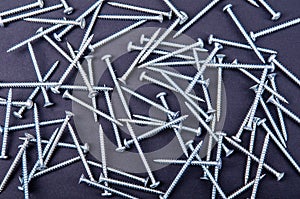 Some screws, bolts on a dark background
