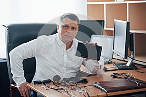 Some serious devices. Polygraph examiner works in the office with his lie detector`s equipment