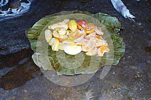 Some slice fruits are isolated on dry green leaves for God