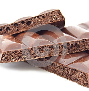 Some slices of black porous chocolate