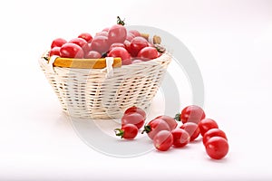 Some small tomatoes isolated on white background in the basket