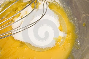 Some sugar poured on egg yolk