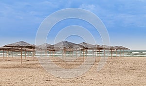 Some sun umbrellas on empty beach