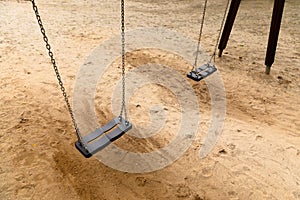 Some swings in the schoolyard closeup photo