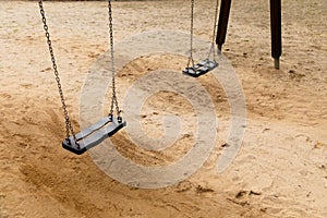 Some swings in the schoolyard closeup photo