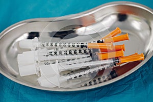 some syringes in a steel medical tray, medical items, taking biomaterial