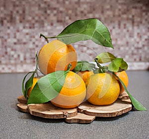 Some tangerins on a wooden stand