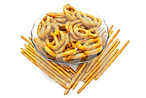Some tasty salted pretzels and breadsticks on white