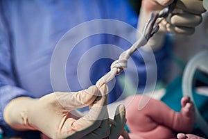 Some ties can never be broken. an unrecognizable doctor holding a babys umbilical chord in hospital.