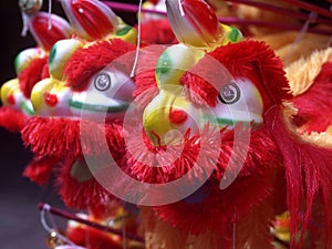 Some toys in the form of a lion dance with various colors
