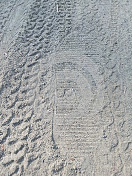 Some tyre prints and footprints on dusty road on crime scene