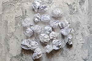 some white paper balls on the table in office, mess in the minds