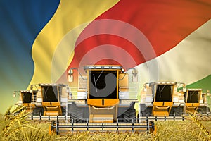 some yellow farming combine harvesters on rural field with Seychelles flag background - front view, stop starving concept -