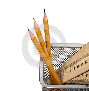 Some yellow pencils and wooden ruler in support